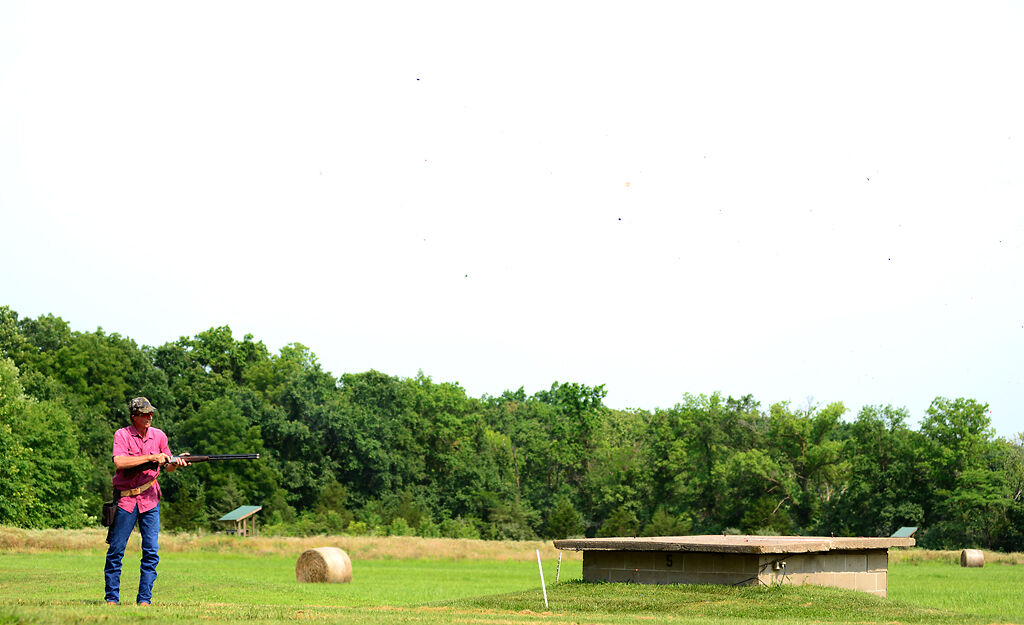 John Brummett stands under an exploding target
